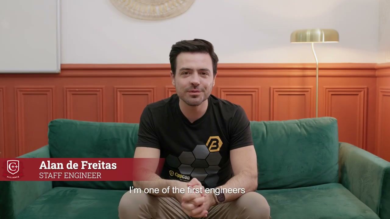 Alan de Freitas being interviewed on a green sofa